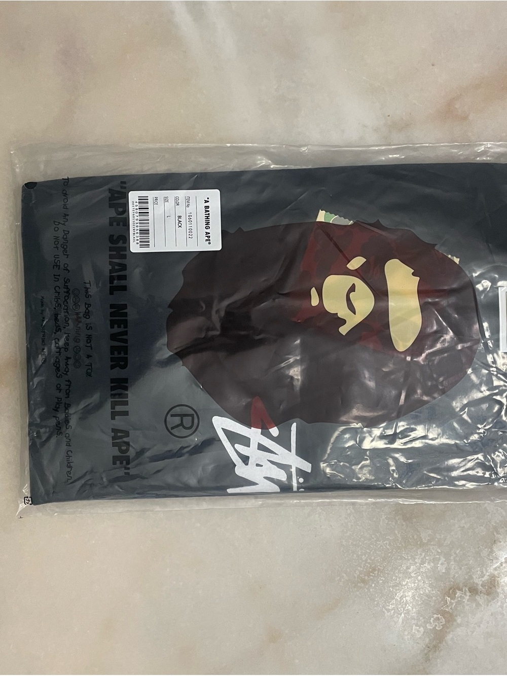 Stussy Black Short Sleeve Tee with Brown and Cream Ape Graphic